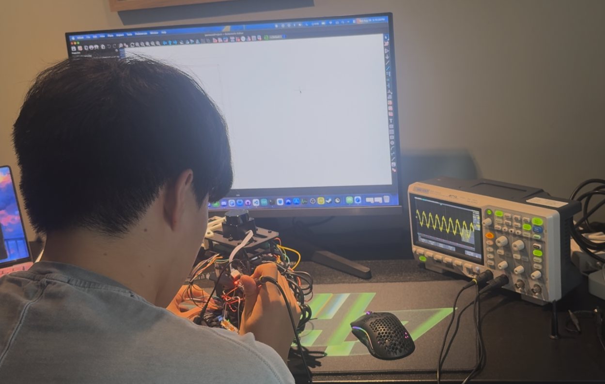 Working on the robot at a bench, with an oscilloscope trace on screen while checking the motor driver board